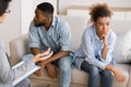 Frustrated Afro Couple Avoiding Eye Contact Sitting At Therapist`s Office
