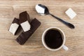 Broken marshmallow in chocolate, coffee in cup, spoon and sugar Royalty Free Stock Photo