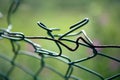 Broken mesh fence as a symbol of defencelessness