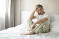 Broken middle aged man sitting on bed in the morning Royalty Free Stock Photo