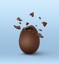 Broken milk chocolate egg on light blue background Royalty Free Stock Photo