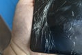 A broken mobile phone screen in the master`s hand Royalty Free Stock Photo