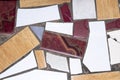 Broken mosaic tile pieces in concrete pavement