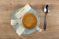 Broken nougat with marmalade, coffee in cup on saucer, spoon on table. Top view Royalty Free Stock Photo