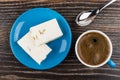 Broken nougat in saucer, coffee in cup, spoon on table Royalty Free Stock Photo