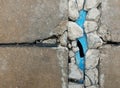 Broken old blue pvc pipe under broken old concrete ground