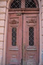 Broken old double red doors with broken windows Royalty Free Stock Photo