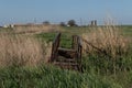 Broken old foot bridge over the river in the fields Royalty Free Stock Photo