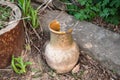 Broken old jug on the ground thrown away