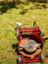 Broken old lawnmower in backyard grass Royalty Free Stock Photo