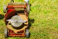 Broken old lawnmower in backyard grass Royalty Free Stock Photo