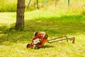 Broken old lawnmower in backyard grass Royalty Free Stock Photo