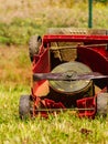 Broken old lawnmower in backyard grass Royalty Free Stock Photo