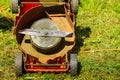 Broken old lawnmower in backyard grass Royalty Free Stock Photo