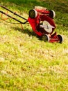 Broken old lawnmower in backyard grass Royalty Free Stock Photo