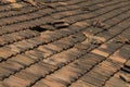 Broken old terracotta rooftiles with hole