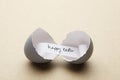 Broken open egg with happy easter message inside Royalty Free Stock Photo