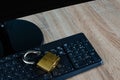 Broken padlock on computer keyboard, concept for Internet and security breach