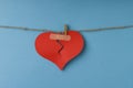 Broken paper heart hanging on rope Royalty Free Stock Photo