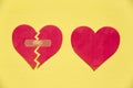 Broken paper heart with patch next to the whole paper heart on y Royalty Free Stock Photo