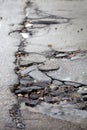 Broken pavement and pothole asphalt road after winter. Royalty Free Stock Photo