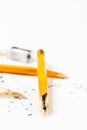 Broken pencil with metal sharpener and shavings. Royalty Free Stock Photo