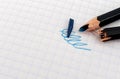 Broken pencil on white checkered paper close-up. cracked pencil Royalty Free Stock Photo