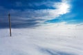 Broken phase electrical power lines on the electric poles on countryside in the winter during the storm and strong wind with snow Royalty Free Stock Photo