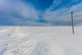 Broken phase electrical power lines on the electric poles on countryside in the winter during the storm and strong wind with snow. Royalty Free Stock Photo