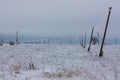 Broken phase electrical power lines with hoarfrost on the wooden electric poles on countryside in the winter after storm Royalty Free Stock Photo