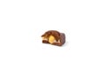 Broken piece of milk chocolate with caramel and nut on a white