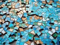 Broken piece of stained glass, with shards and pieces of blue, green, yellow, and orange tiles. These colors create an Royalty Free Stock Photo