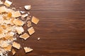 Broken pieces of caramel candy on wooden table Royalty Free Stock Photo