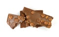 A broken pieces of chocolate with hazelnuts isolated on white background. Royalty Free Stock Photo