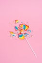 Broken in pieces Colorful lollipop on pastel pink background, top view. Candy colours. Minimal Sugar detox and junk food Royalty Free Stock Photo