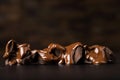 broken pieces pouring with melted chocolate on black table Royalty Free Stock Photo