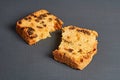 Broken pieces of tasty sweet homemade bread with raisin lies on dark concrete table in kitchen Royalty Free Stock Photo