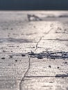 Broken pieces of thick ice over frozen lake shine in sun. Royalty Free Stock Photo