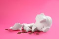 Broken piggy bank with coins on background Royalty Free Stock Photo