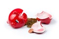 Broken piggy bank with coins on white Royalty Free Stock Photo