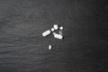 Broken Pills, Crushed Aspirin, Split Tablet, Broken Pill Capsules, Crumbling White Drugs on Black