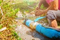 Broken pipe in hole with water motion at roadside and plumber working repair and Locking Pliers Royalty Free Stock Photo