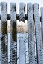 Wooden fence covered with snow, close-up