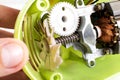 A broken plastic gear in a poor quality hand kitchen mixer. Low-quality home appliances concept, macro Royalty Free Stock Photo