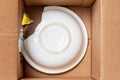 Broken plate in a cardboard box Royalty Free Stock Photo