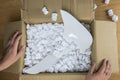 Broken plate in damaged cardboard box top view, damaged home delivery unpacking box Royalty Free Stock Photo