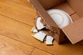 Broken plate in a cardboard box Royalty Free Stock Photo