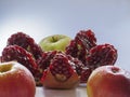 Broken pomegranate and apples on a light background