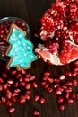 Broken Pomegranate, Seeds and Gingerbread Xmas Tree Cookie Royalty Free Stock Photo