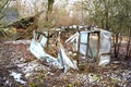 Broken primitive plastic greenhouse in farm garden